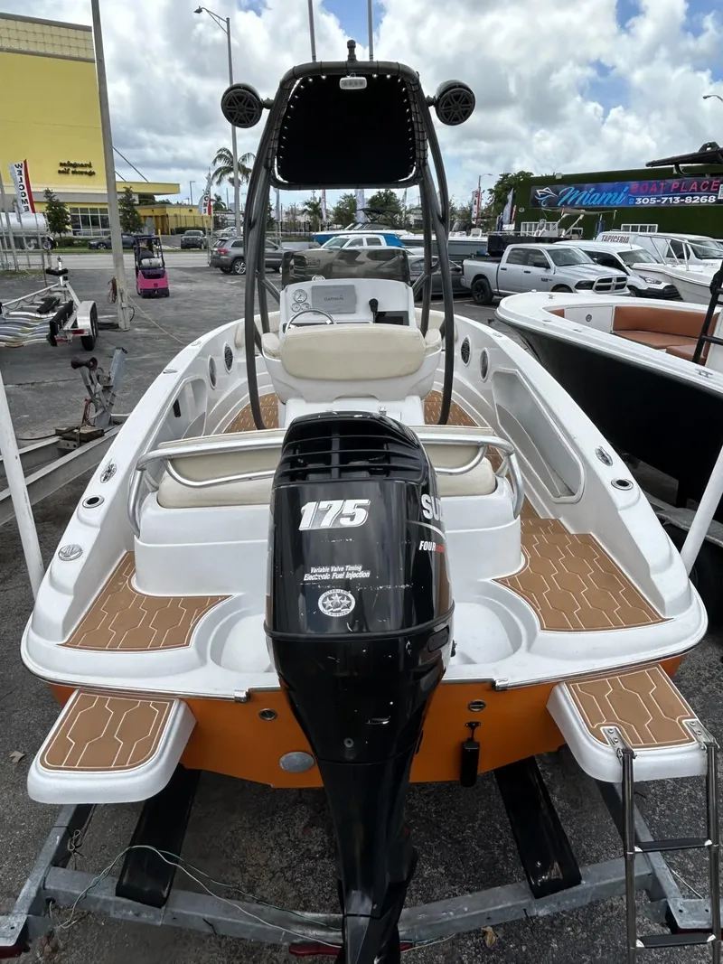 Slide: The Image of 2016 Pronautica 660 boat with Suzuki 175 outboard motor, docked in a marina. - 7