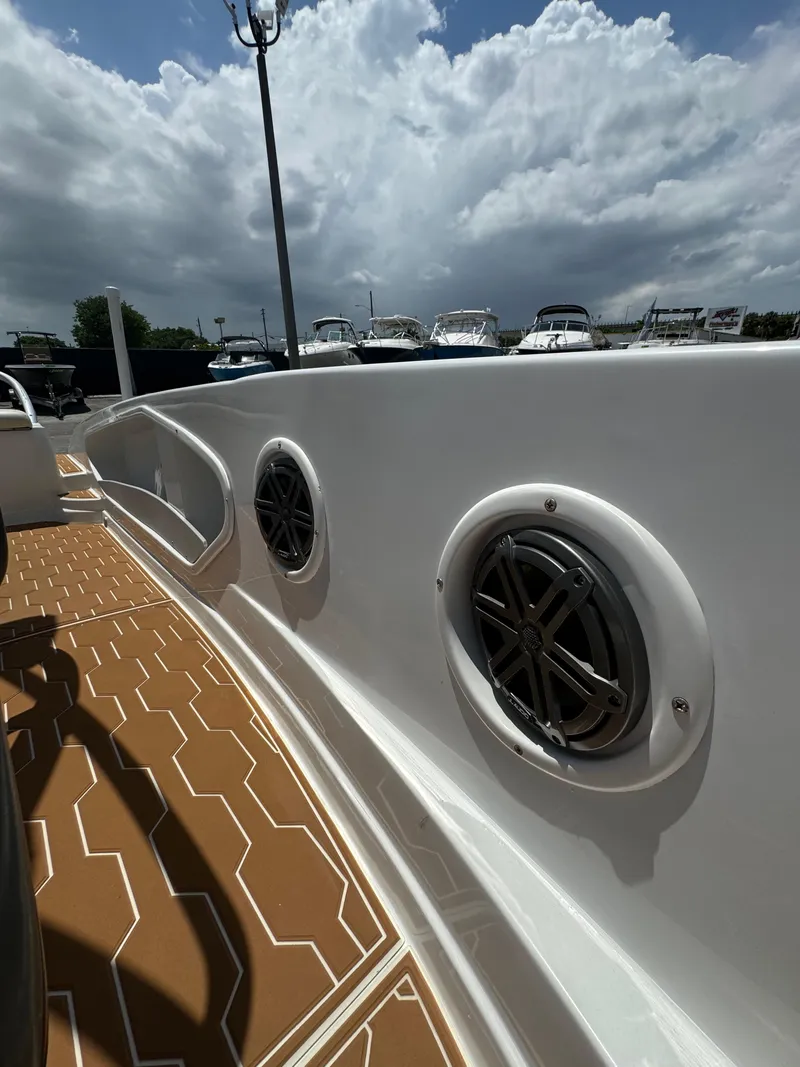 Slide: The Image of 2016 Pronautica 660 boat deck with speakers and marina background. - 9