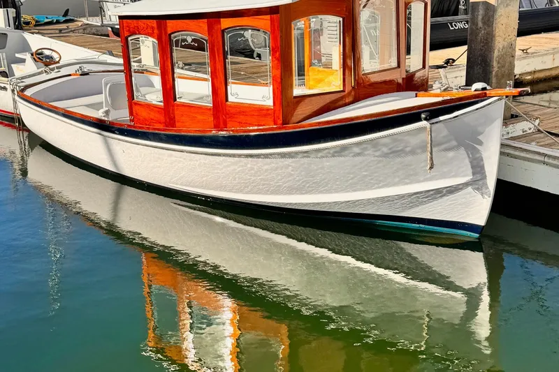 The Image of 1984 Duffy 20 Hardtop Diesel boat docked, reflecting on calm water. - 0