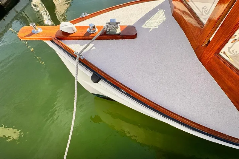 Slide: The Image of Bow of 1984 Duffy 20 Hardtop Diesel boat docked in green water. - 3