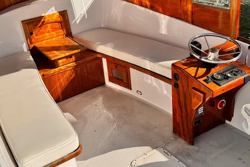 Slide: The Image of Interior of a 1984 Duffy 20 Hardtop Diesel boat with wooden helm and seating. - 4