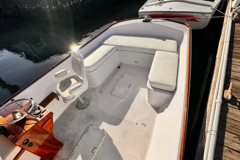 Slide: The Image of 1984 Duffy 20 Hardtop Diesel boat with white seating and wooden helm. - 8