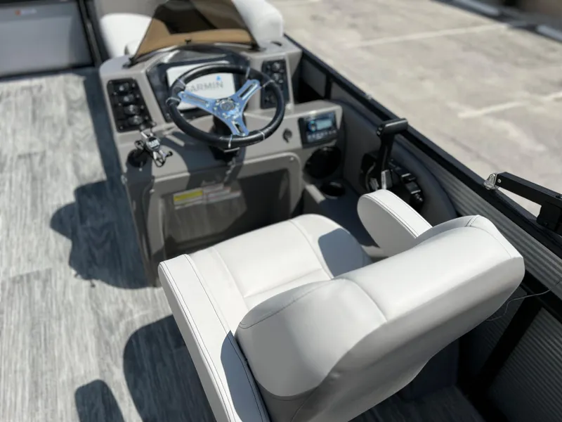 Slide: The Image of 2024 Qwest XRE 820 boat interior with steering wheel and captain's chair. - 10