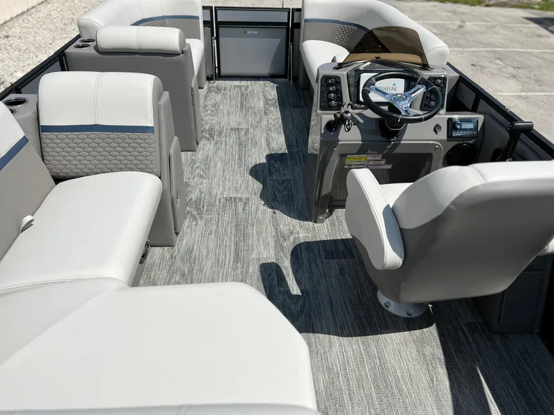 Slide: The Image of 2024 Qwest XRE 820 boat interior with modern seating and steering console. - 13