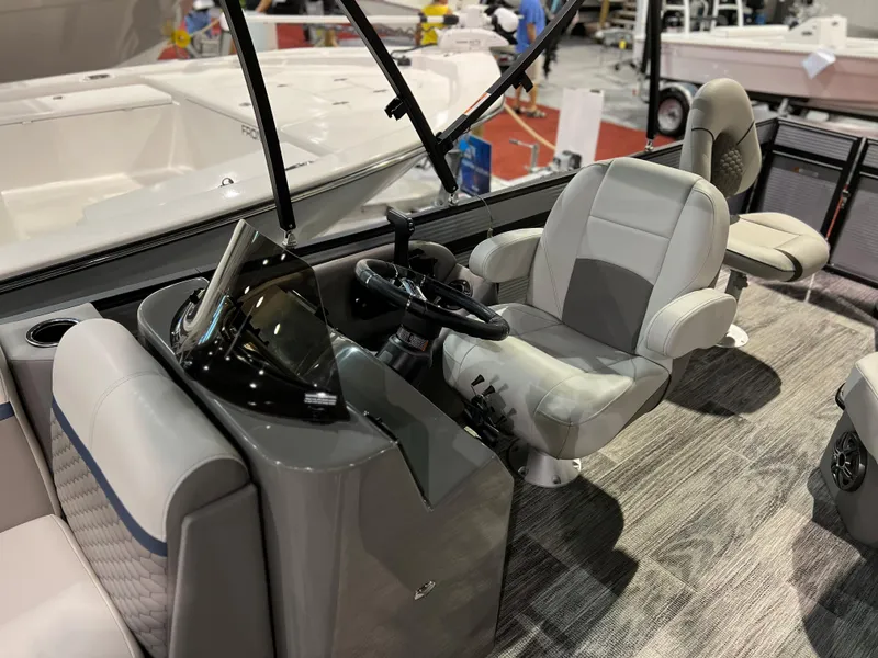 Slide: The Image of 2024 Qwest XRE 820 boat interior with steering console and captain's chair. - 20