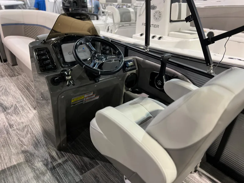 Slide: The Image of 2024 Qwest XRE 820 boat interior with steering console and seating. - 21