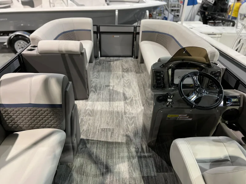 Slide: The Image of 2024 Qwest XRE 820 boat interior with modern seating and steering console. - 23