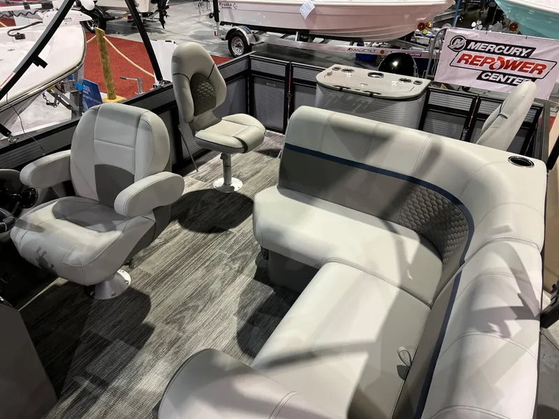 Slide: The Image of 2024 Qwest XRE 820 boat interior with plush seating at Mercury Repower Center. - 25