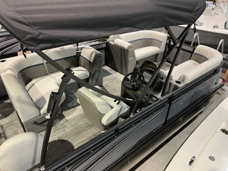 Slide: The Image of 2024 Qwest XRE 820 pontoon boat interior with seating and steering console. - 28