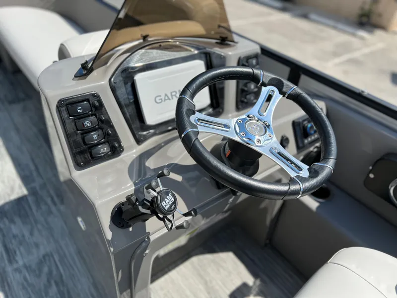 Slide: The Image of 2024 Qwest XRE 820 boat dashboard with Garmin navigation system and steering wheel. - 9