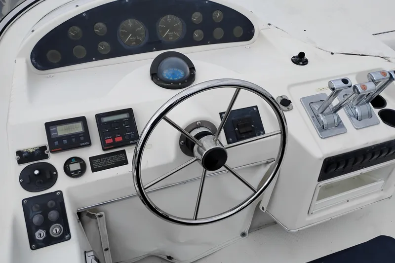 Slide: The Image of 1995 Bayliner 3988 Motoryacht helm with steering wheel and control panel. - 10