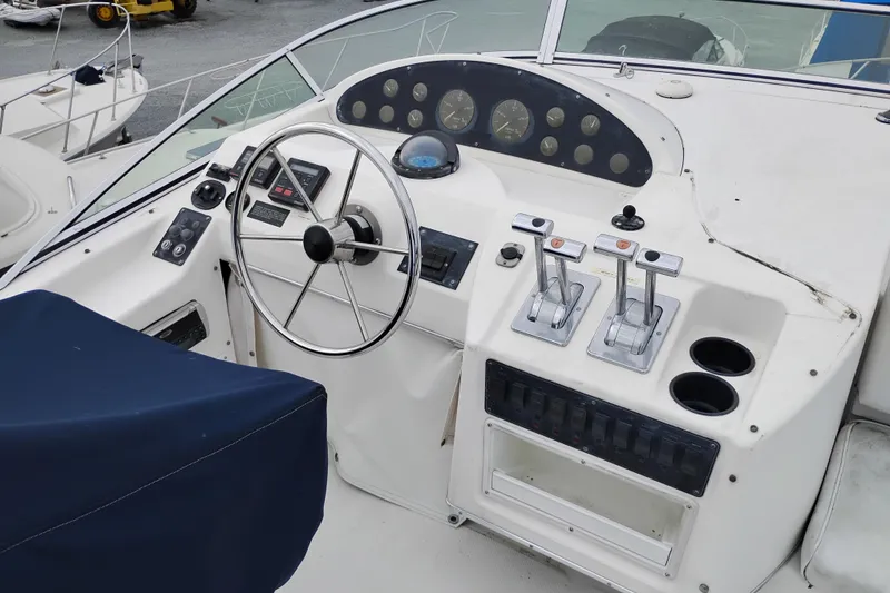 Slide: The Image of 1995 Bayliner 3988 Motoryacht helm with steering wheel, controls, and gauges. - 12