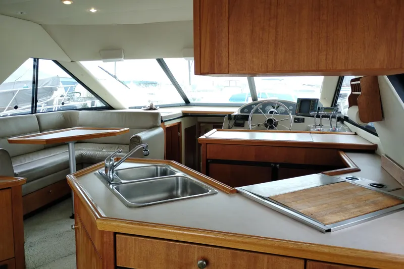 Slide: The Image of Interior of 1995 Bayliner 3988 Motoryacht with kitchen, seating, and helm station. - 18
