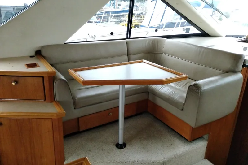 Slide: The Image of 1995 Bayliner 3988 Motoryacht interior with cozy seating and wooden table. - 19