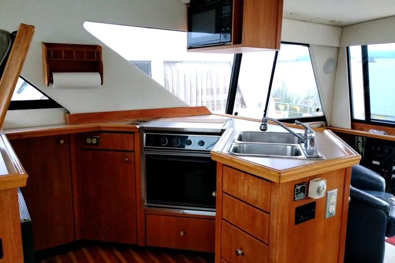 Slide: The Image of Interior of 1995 Bayliner 3988 Motoryacht kitchen with wood cabinetry and modern appliances. - 20
