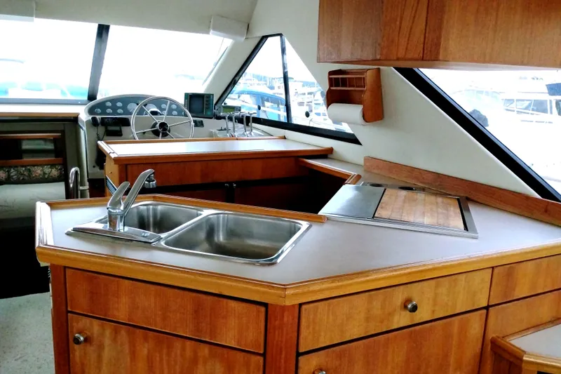 Slide: The Image of Interior of 1995 Bayliner 3988 Motoryacht with wooden cabinetry and dual sink. - 21