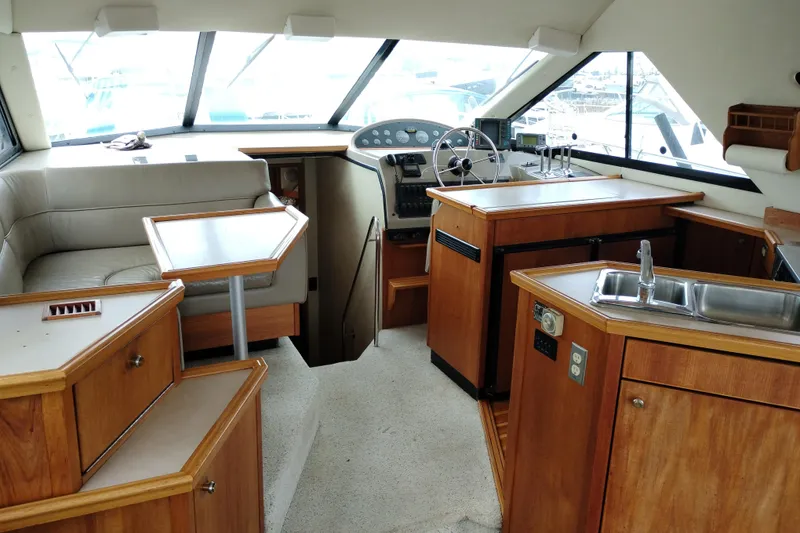 Slide: The Image of Interior of 1995 Bayliner 3988 Motoryacht with helm, seating, and kitchenette. - 27