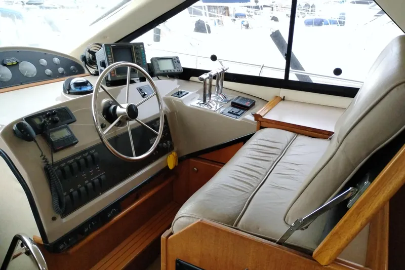 Slide: The Image of 1995 Bayliner 3988 Motoryacht helm with steering wheel, navigation equipment, and comfortable seating. - 29