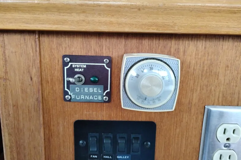 Slide: The Image of Diesel furnace control panel on 1995 Bayliner 3988 Motoryacht, featuring thermostat and switches. - 33