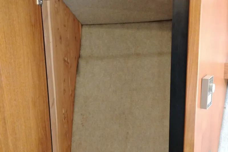 Slide: The Image of Interior view of 1995 Bayliner 3988 Motoryacht storage compartment with wooden door. - 38