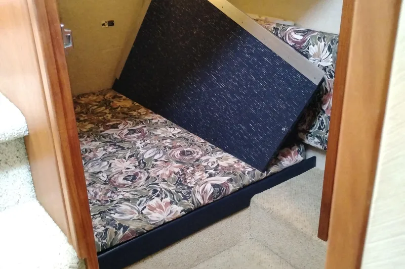 Slide: The Image of 1995 Bayliner 3988 Motoryacht interior with floral-patterned bedding and carpeted stairs. - 39