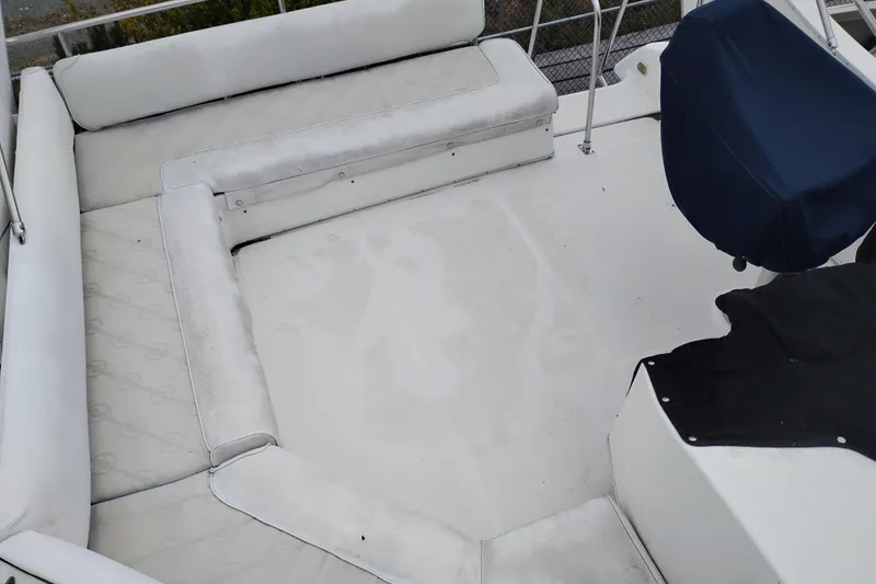 Slide: The Image of 1995 Bayliner 3988 Motoryacht deck with white seating and covered helm. - 7