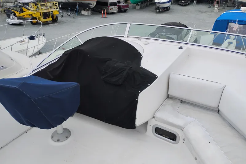 Slide: The Image of 1995 Bayliner 3988 Motoryacht deck with covered seating and equipment. - 9