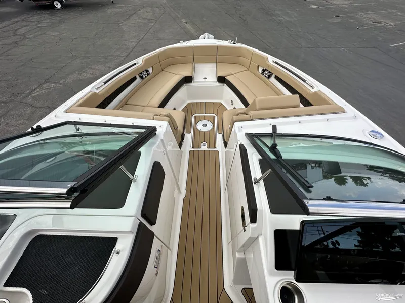 Slide: The Image of 2024 Sea Ray 310 SLX boat interior with tan seating and sleek design. - 10