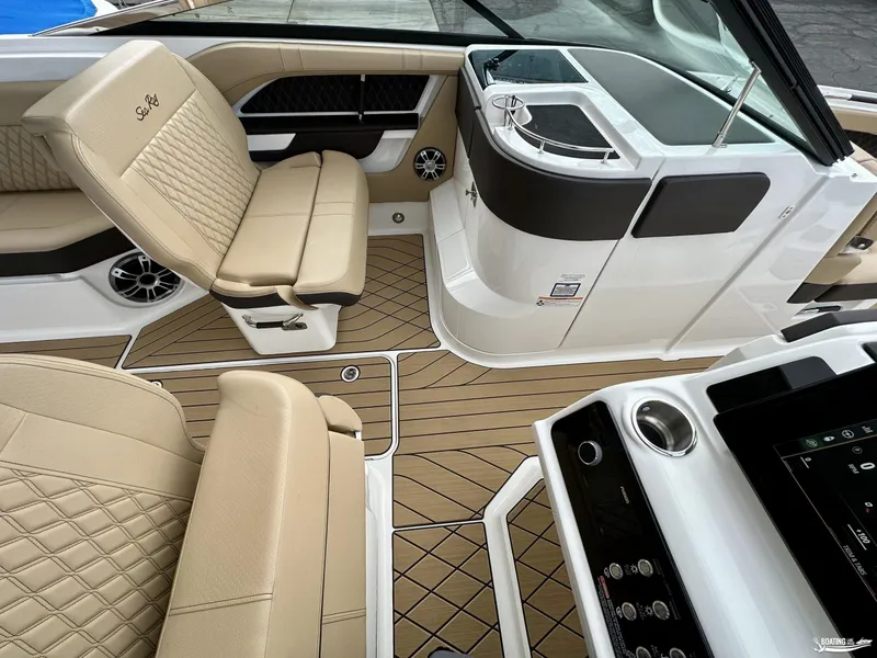 Slide: The Image of Luxurious interior of 2024 Sea Ray 310 SLX boat with beige seating and modern dashboard. - 13