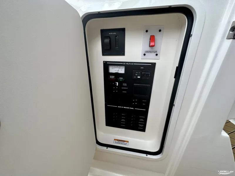 Slide: The Image of 2024 Sea Ray 310 SLX electrical panel with control switches and safety features. - 14
