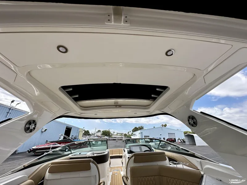 Slide: The Image of 2024 Sea Ray 310 SLX boat interior with open sunroof and luxurious seating. - 5