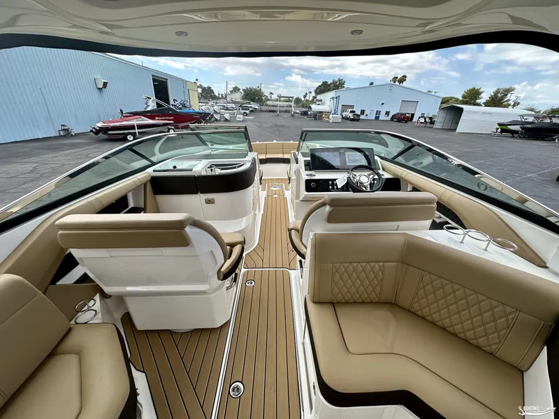 Slide: The Image of 2024 Sea Ray 310 SLX boat interior with luxurious seating and modern dashboard. - 6