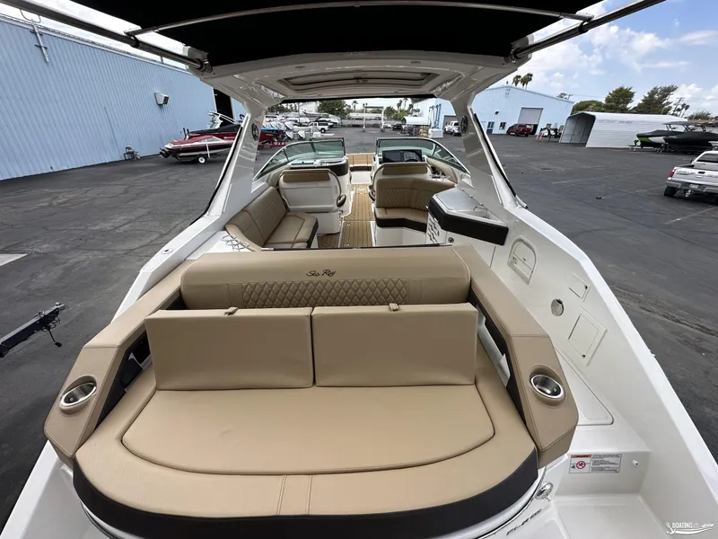 Slide: The Image of 2024 Sea Ray 310 SLX luxury boat interior with beige seating and modern design. - 7
