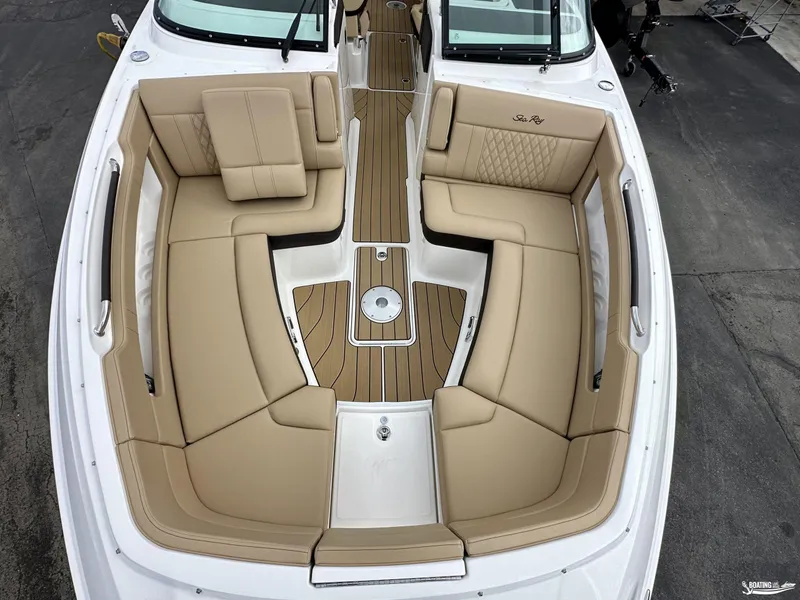 Slide: The Image of 2024 Sea Ray 310 SLX boat interior with tan seating and wood accents. - 8