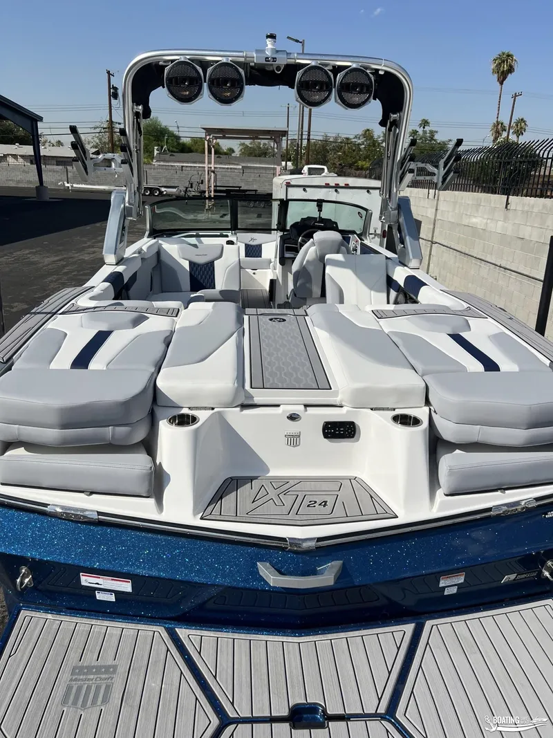 Slide: The Image of 2023 MasterCraft XT24 boat with sleek design and spacious seating. - 1