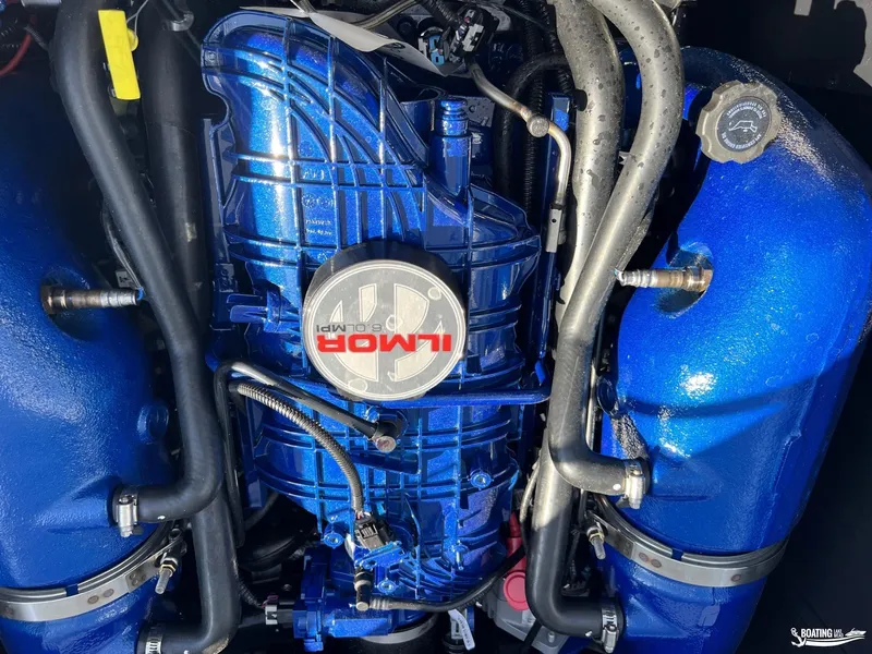 Slide: The Image of 2023 MasterCraft XT24 engine, Ilmor 6.0L, vibrant blue components. - 11