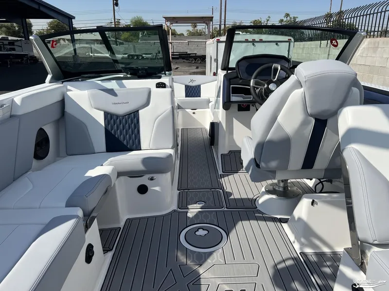 Slide: The Image of 2023 MasterCraft XT24 boat interior with modern seating and steering wheel. - 2