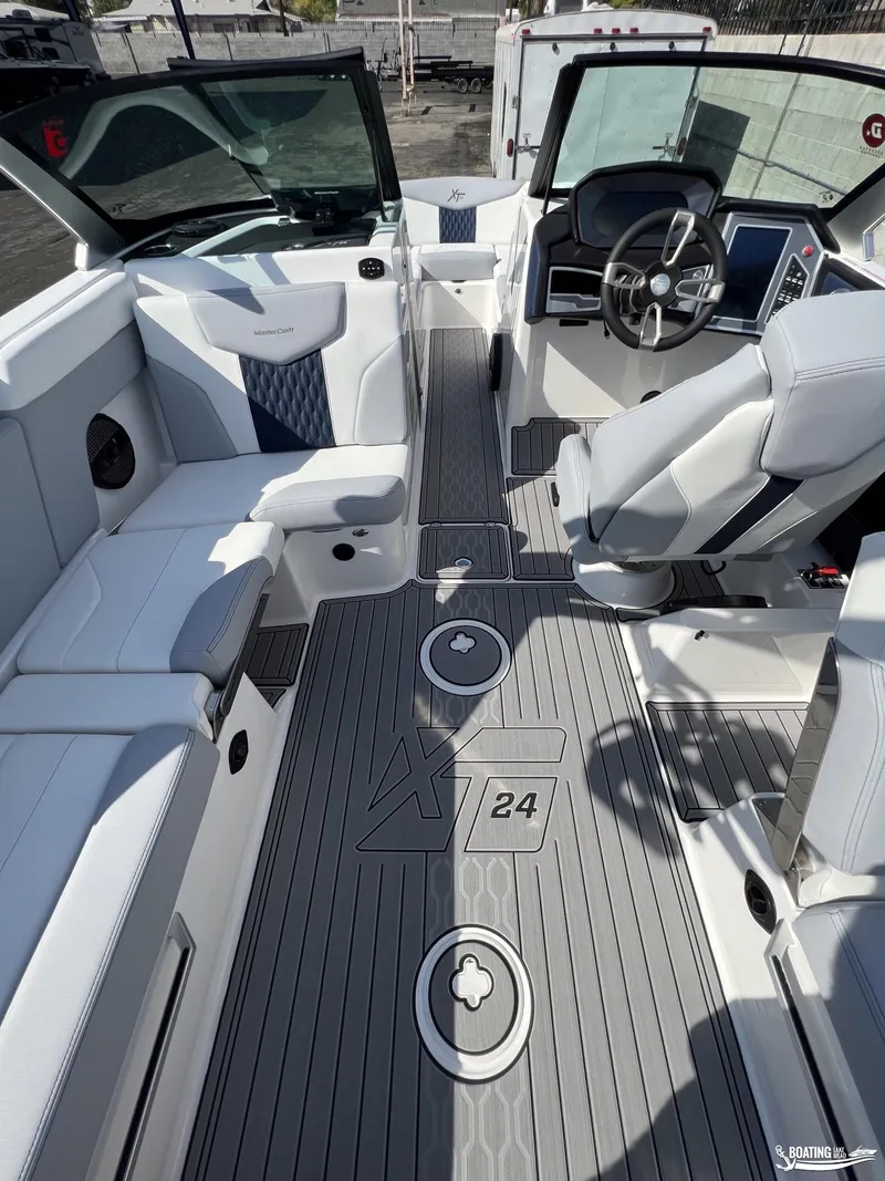 Slide: The Image of 2023 MasterCraft XT24 boat interior with modern seating and steering console. - 4
