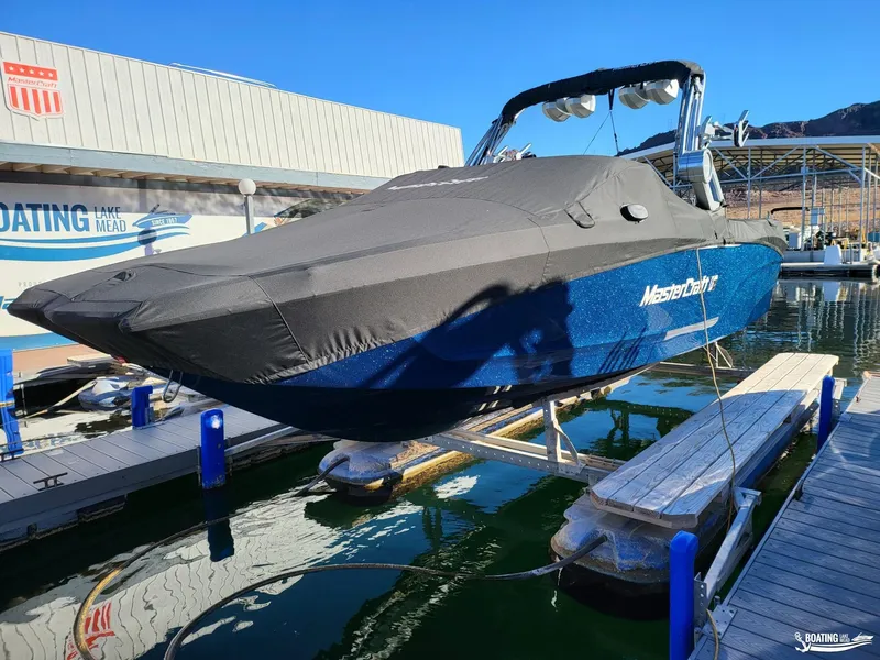 Slide: The Image of 2023 MasterCraft XT24 boat docked at Lake Mead marina. - 8