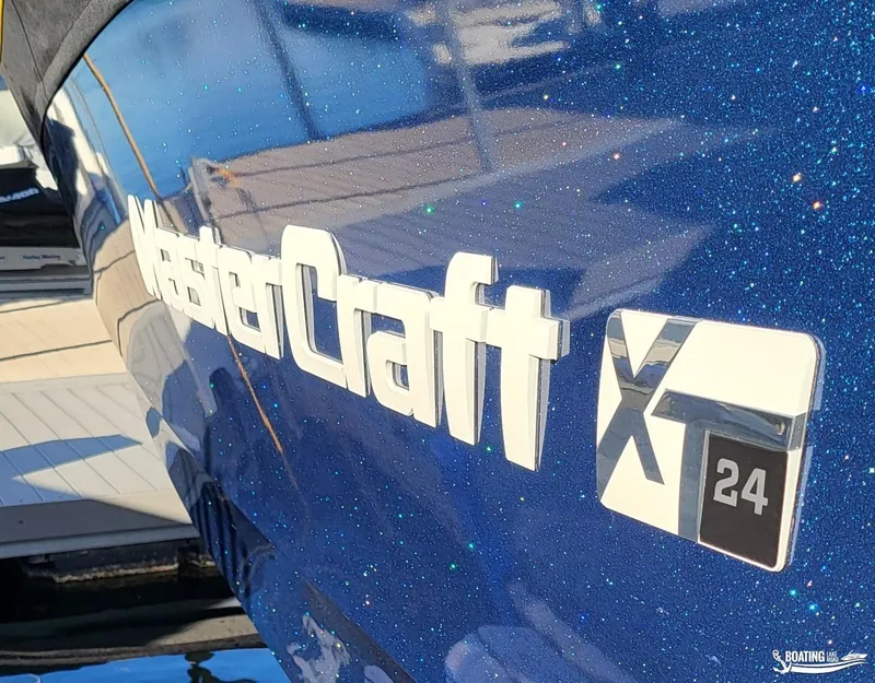 Slide: The Image of 2023 MasterCraft XT24 boat with blue metallic finish at dock. - 9