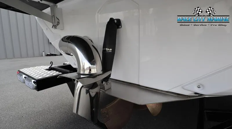 Slide: The Image of 2024 Nautique GS22 boat rear view with propeller and exhaust system. - 12