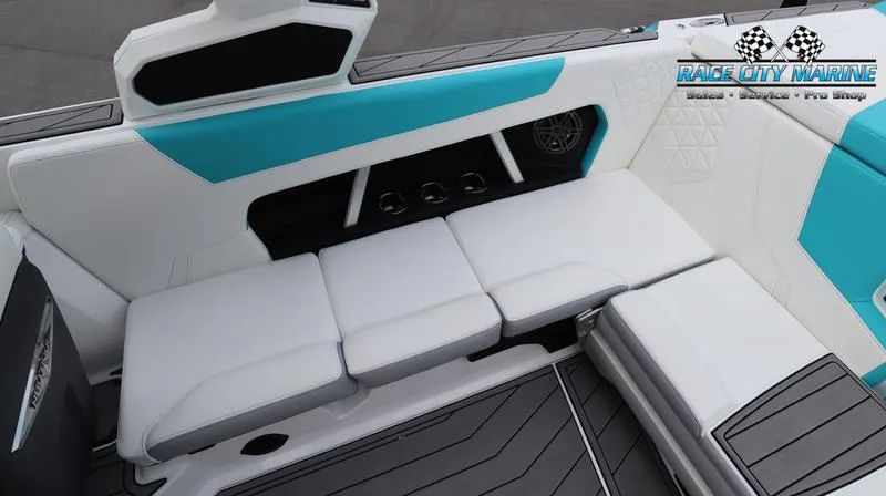Slide: The Image of 2024 Nautique GS22 boat interior with white and teal seating. - 19