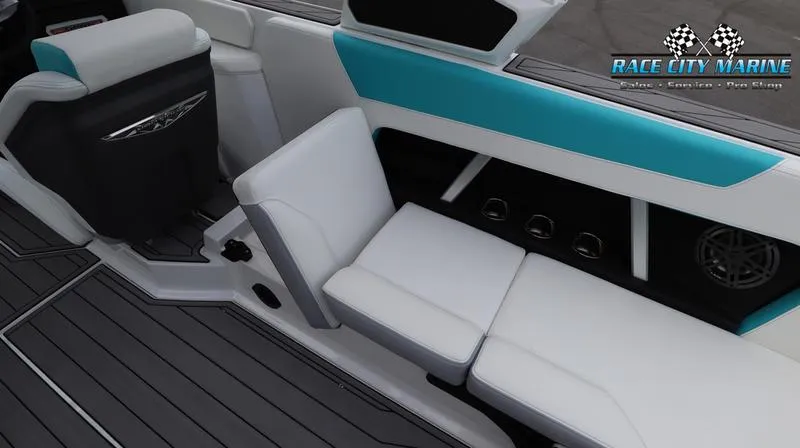 Slide: The Image of 2024 Nautique GS22 boat interior with white and teal seating, Race City Marine logo. - 21