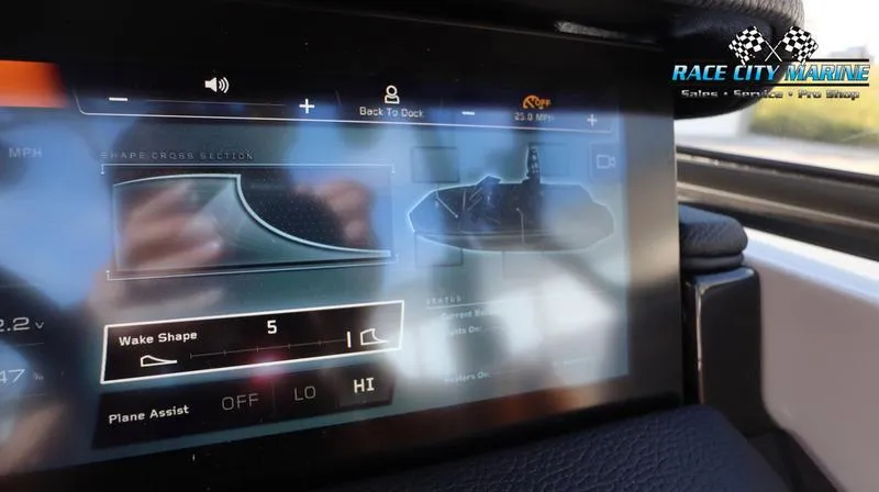 Slide: The Image of 2024 Nautique GS22 touchscreen control panel displaying wake shape and plane assist settings. - 24