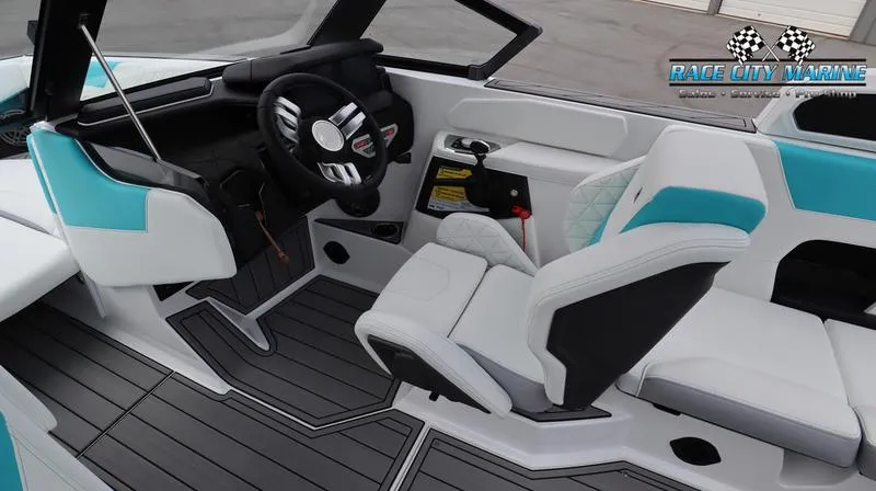 Slide: The Image of 2024 Nautique GS22 boat interior with modern helm and seating. - 28