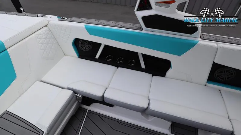Slide: The Image of 2024 Nautique GS22 boat interior with white and teal seating. - 35