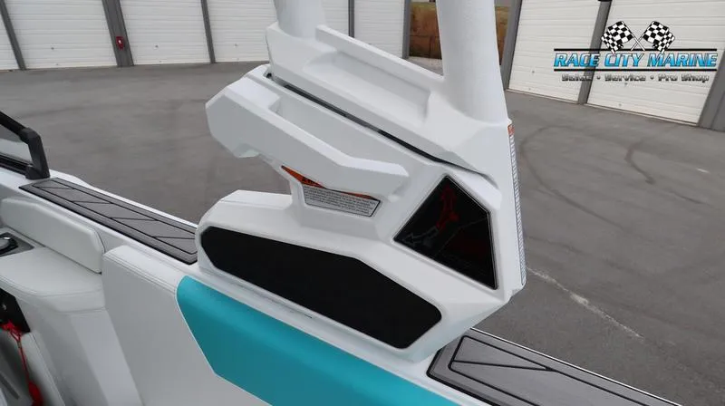 Slide: The Image of 2024 Nautique GS22 boat interior detail with white and turquoise upholstery. - 37