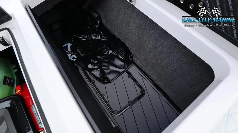 Slide: The Image of 2024 Nautique GS22 storage compartment with Race City Marine logo. - 42