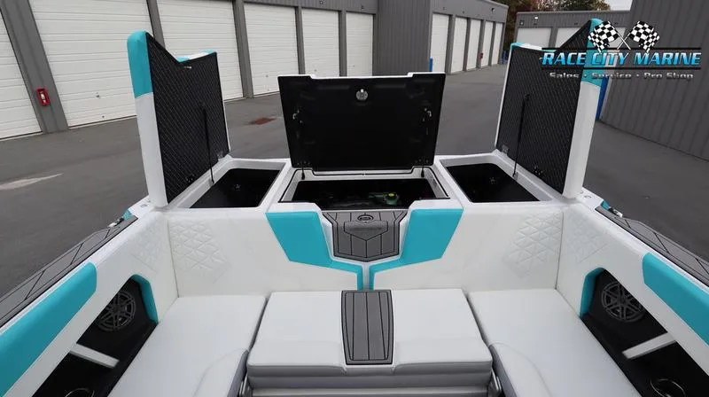 Slide: The Image of 2024 Nautique GS22 boat interior with open storage compartments at Race City Marine. - 43