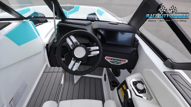 Slide: The Image of 2024 Nautique GS22 boat cockpit with steering wheel and dashboard. - 44